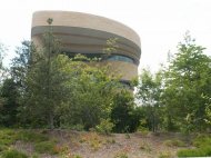 Stand at the foot of Capitol Hill and look westward from the intersection of Maryland Ave. and 3rd St., S.W. The National Museum of the American Indian looms ahead, like a massive natural stone formation from the American West.